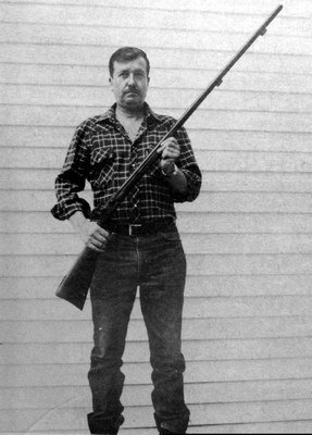 John McGeorge holding a rifle.