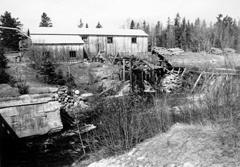 Photograph of Adam&#039;s Lumber Mill in York Mills, taken in the 1950&#039;s. Image shows dammed head pond and piled logs waiting to be sawed. Mill remained unchanged into the 1970s. Image thanks to J. Hall.
