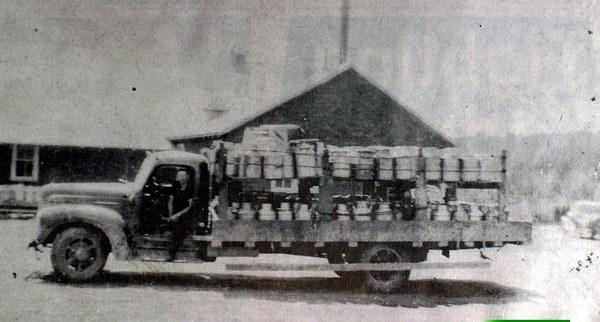 Photograph of Harvey Creamery in June, 1941. The truck driven by George Tracy was loaded with 310 cans of cream which had been picked up between Lower Queensbury by Pokiok and Long&#039;s Creek. Photograph in collection of George Tracey. Image courtesy of J. Hall.